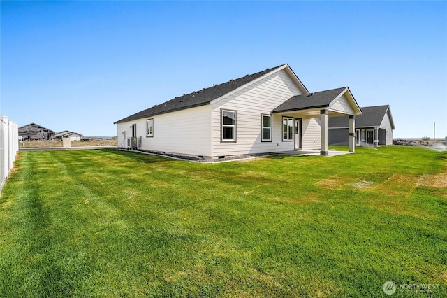 back of house with a yard and crawl space