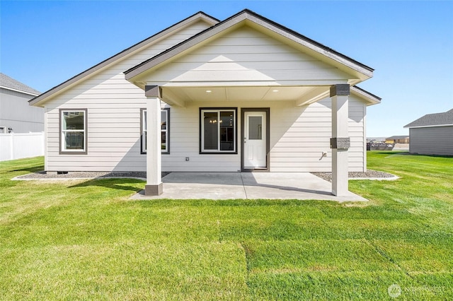 back of property featuring a yard and a patio