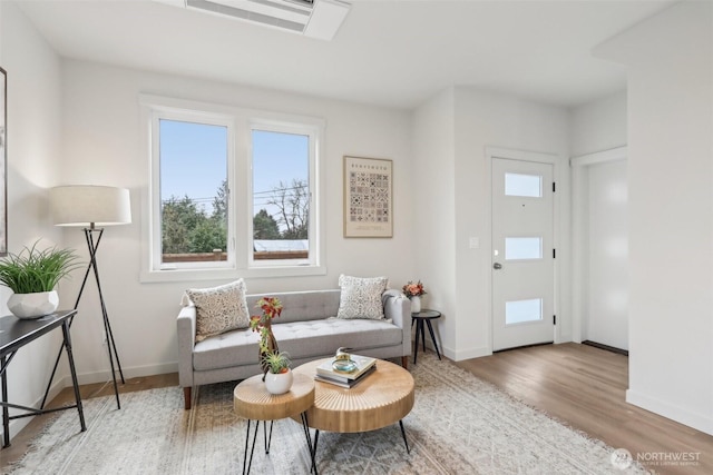 living room with baseboards and wood finished floors