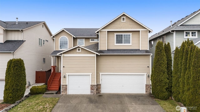 craftsman-style home featuring a garage, stone siding, a shingled roof, and concrete driveway