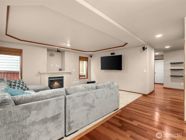 living area with plenty of natural light, a fireplace, wood finished floors, and recessed lighting