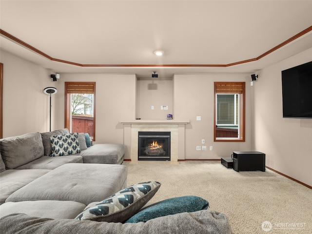 living room with carpet, baseboards, and a tiled fireplace