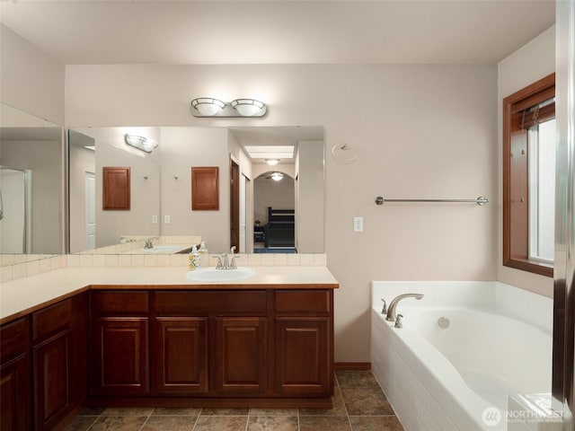 bathroom featuring vanity and a bath