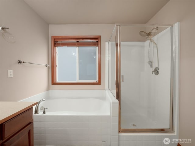 full bath with a stall shower, a garden tub, and vanity