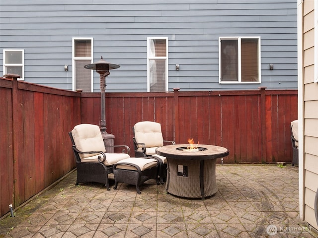 view of patio / terrace featuring an outdoor fire pit, a fenced backyard, and central air condition unit