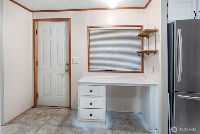 6612 NE Pear St, Suquamish, WA 98392 - interior space featuring white cabinetry, light countertops, crown molding, and freestanding refrigerator