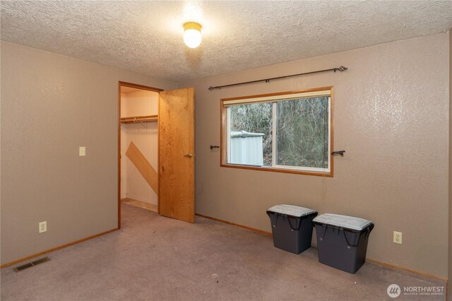 6612 NE Pear St, Suquamish, WA 98392 - unfurnished bedroom featuring a textured ceiling, a textured wall, visible vents, baseboards, and carpet