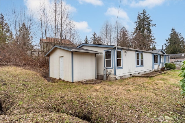 6612 NE Pear St, Suquamish, WA 98392 - view of property exterior with crawl space and a lawn