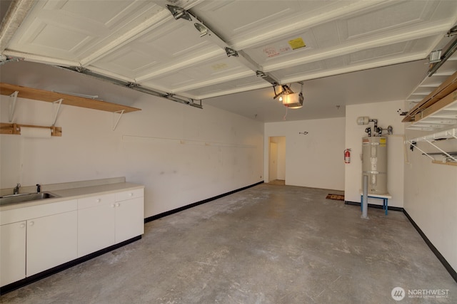 garage featuring water heater, a garage door opener, baseboards, and a sink