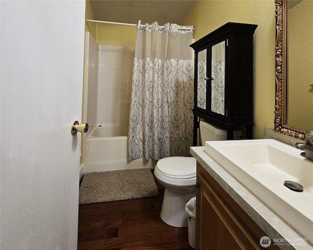 full bathroom with toilet, shower / bathtub combination with curtain, wood finished floors, and vanity