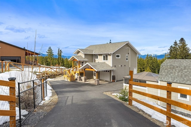 exterior space with an outdoor structure, fence, and driveway