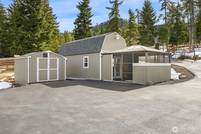 view of shed with fence