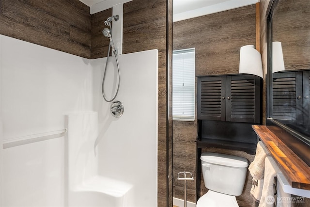 bathroom with a shower stall and toilet