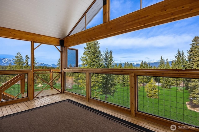 unfurnished sunroom with a mountain view and plenty of natural light