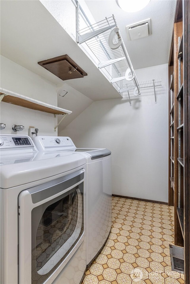 laundry room with laundry area, visible vents, washer and clothes dryer, and light floors