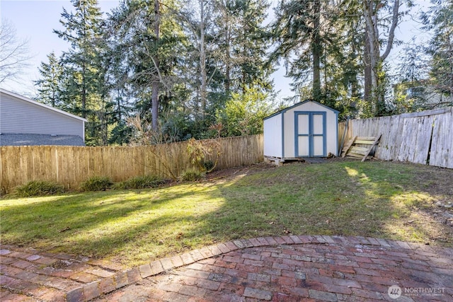 view of yard with a patio area, a fenced backyard, an outdoor structure, and a shed