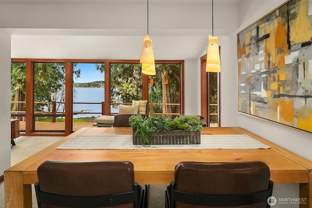 dining space featuring a water view