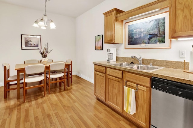 kitchen featuring a sink, baseboards, light wood-style floors, stainless steel dishwasher, and pendant lighting