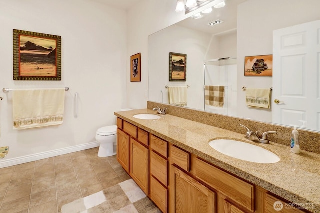 bathroom featuring walk in shower, a sink, toilet, and double vanity