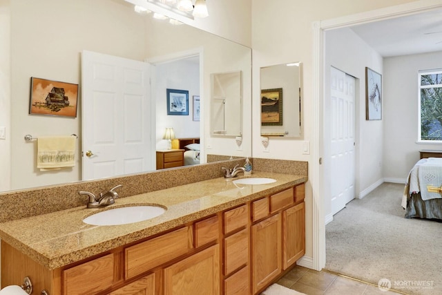 full bathroom featuring tile patterned flooring, a sink, ensuite bath, and double vanity