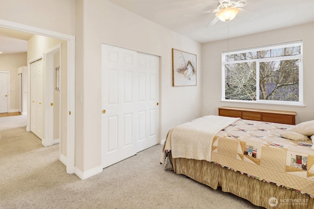 bedroom with a closet, carpet flooring, ceiling fan, and baseboards