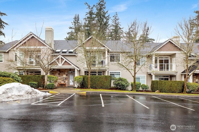 view of building exterior with uncovered parking