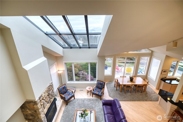 living room with a skylight and wood finished floors