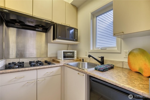 kitchen with extractor fan, a toaster, a sink, light countertops, and black appliances