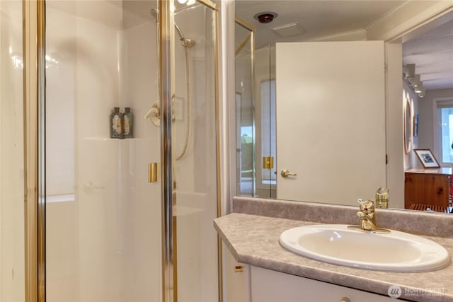 bathroom featuring a shower stall and vanity