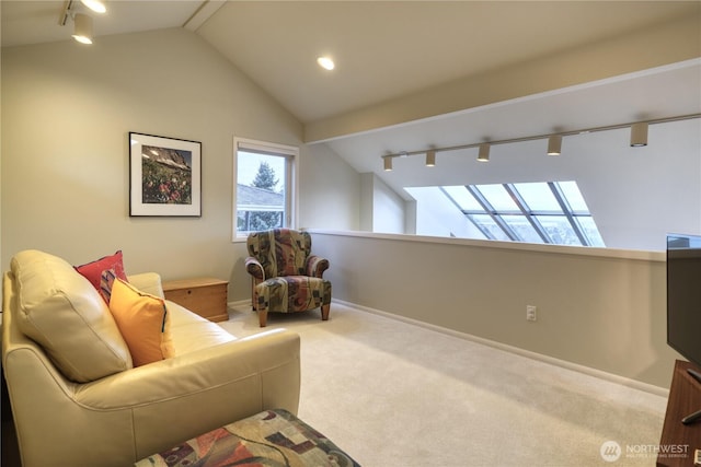 living area with rail lighting, baseboards, vaulted ceiling, and carpet flooring