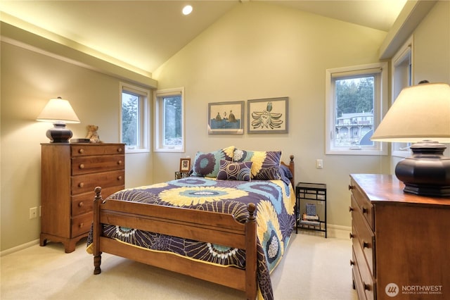 bedroom with light carpet, multiple windows, and lofted ceiling