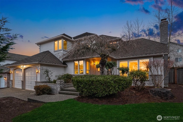 view of front of house with a garage and concrete driveway