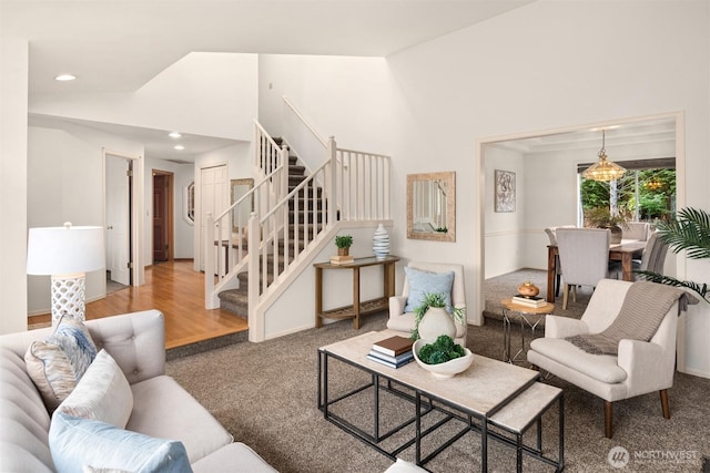 living room with carpet floors, stairs, high vaulted ceiling, and recessed lighting