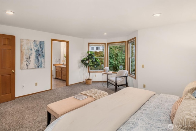 bedroom featuring recessed lighting, connected bathroom, light colored carpet, and baseboards