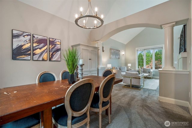 carpeted dining area featuring lofted ceiling, arched walkways, and decorative columns