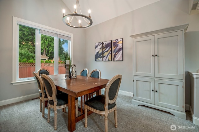 dining room with light carpet, baseboards, and a notable chandelier