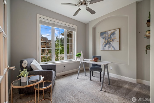 home office featuring carpet floors, a ceiling fan, and baseboards