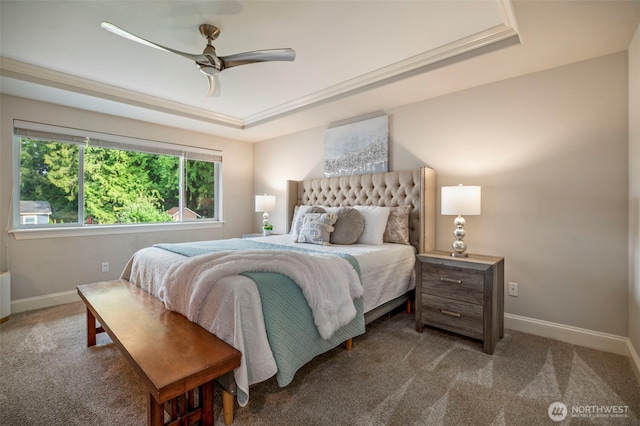 bedroom with ceiling fan, a raised ceiling, carpet flooring, and baseboards