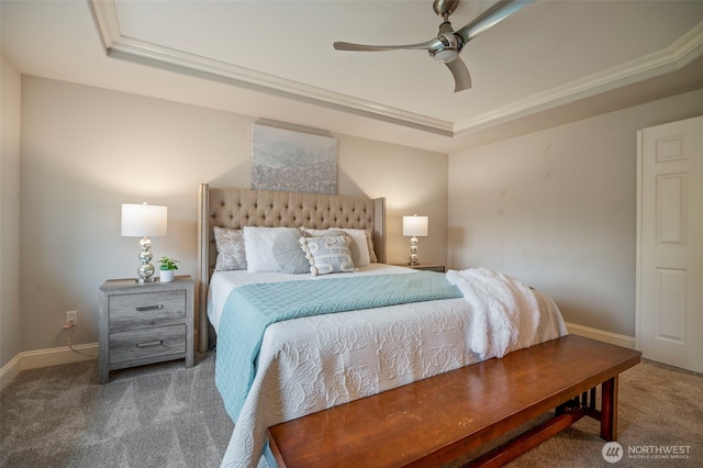 bedroom featuring carpet, crown molding, a raised ceiling, ceiling fan, and baseboards