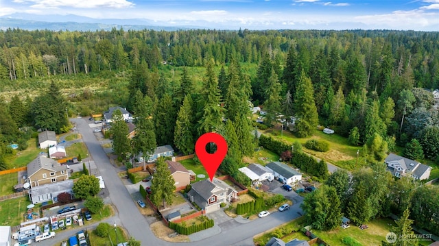 birds eye view of property with a forest view