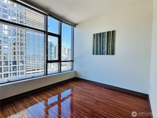 empty room featuring baseboards and a city view