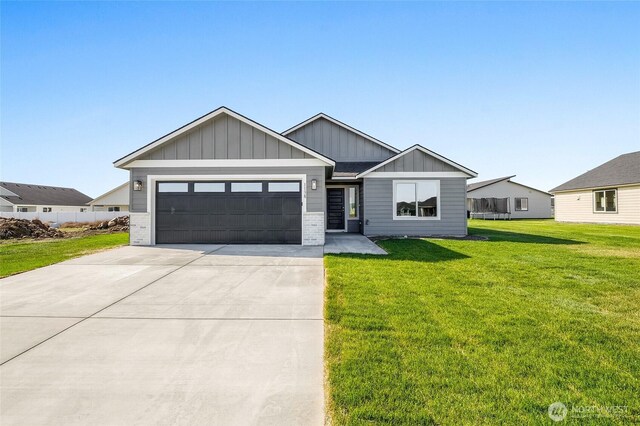 1138 8th Ave NE, Ephrata, WA 98823 - craftsman-style home with brick siding, a garage, board and batten siding, a front yard, and driveway