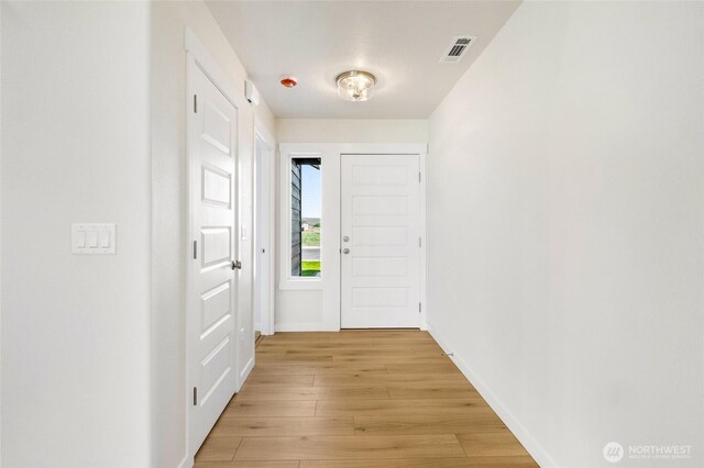 1138 8th Ave NE, Ephrata, WA 98823 - doorway to outside featuring baseboards, light wood-style flooring, and visible vents