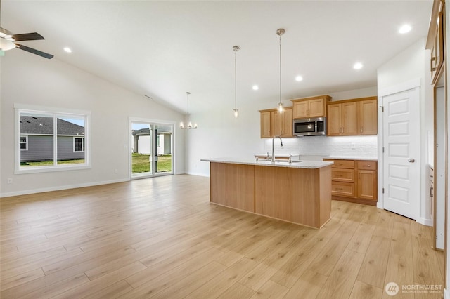 1138 8th Ave NE, Ephrata, WA 98823 - kitchen with backsplash, stainless steel microwave, open floor plan, and a sink