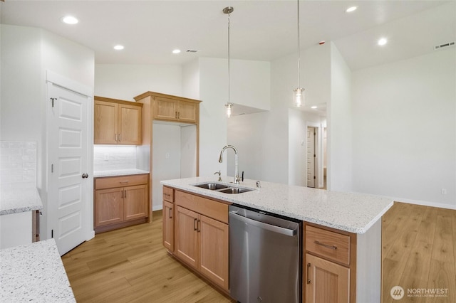 1138 8th Ave NE, Ephrata, WA 98823 - kitchen with light stone counters, a sink, dishwasher, light wood-style flooring, and visible vents