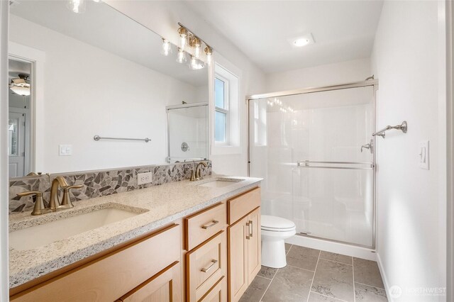 1138 8th Ave NE, Ephrata, WA 98823 - bathroom featuring a sink, a shower stall, toilet, and double vanity
