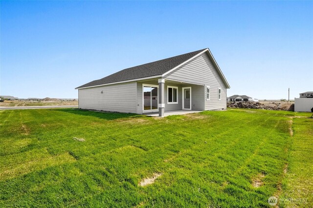1138 8th Ave NE, Ephrata, WA 98823 - back of house featuring a yard and a patio