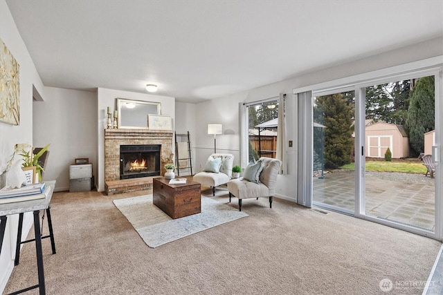 living area featuring carpet and a brick fireplace