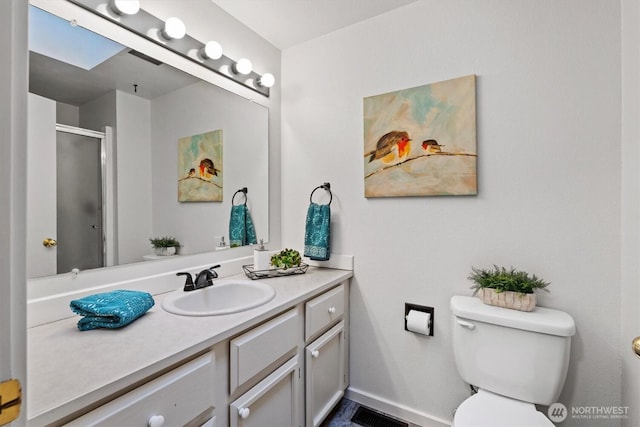 bathroom with a skylight, visible vents, toilet, an enclosed shower, and vanity