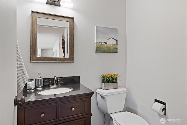 half bath featuring toilet and vanity